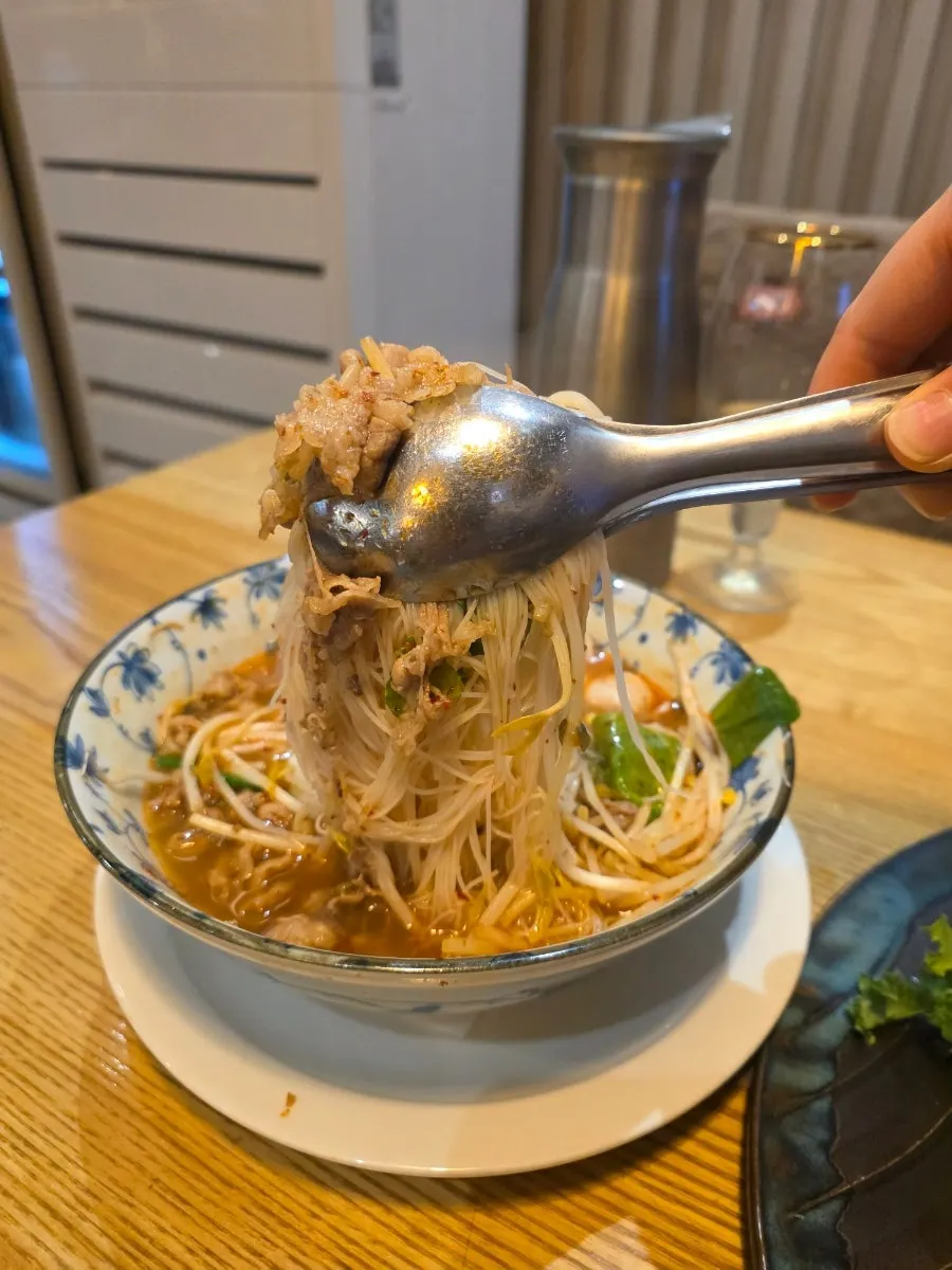 Saeng Augustine's tom yum goong pho with meat and noodles together