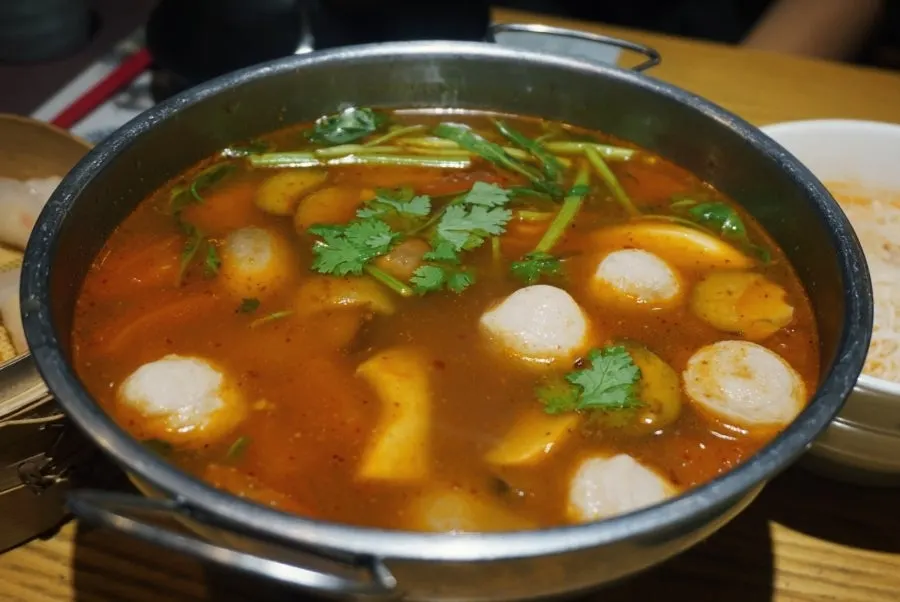A bowl of tom yum goong loaded with seafood