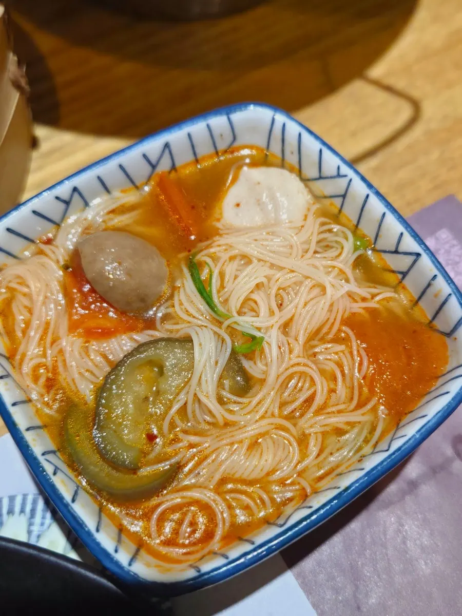 Rice noodles soaked in tom yum broth