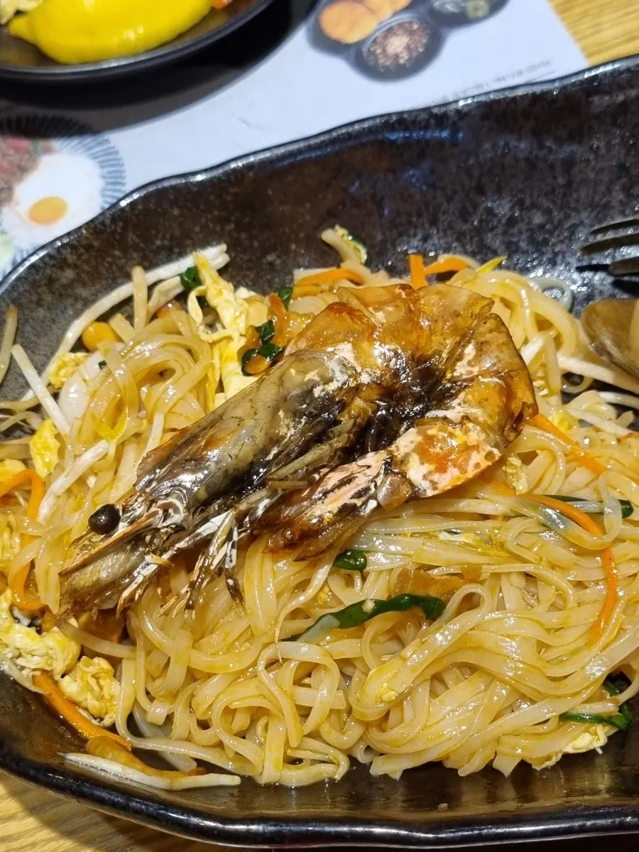Close-up of the large giant prawn on the pad thai