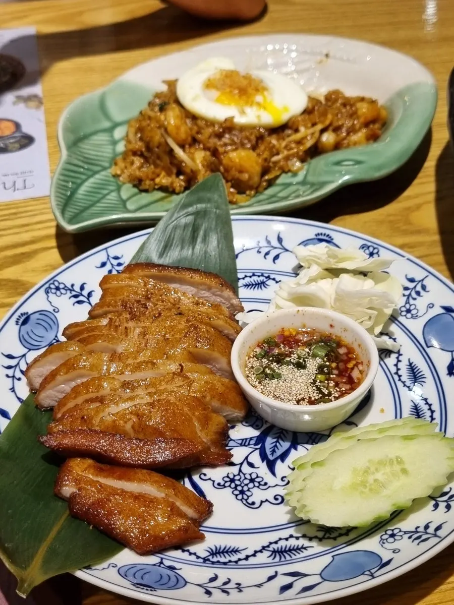Pad thai and nasi goreng placed together on the table