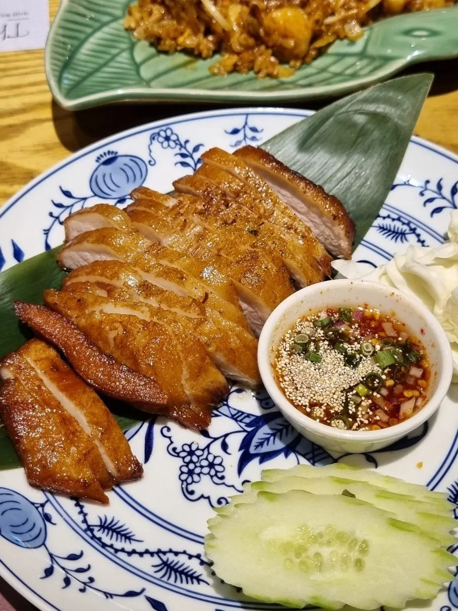 Khor moo yang served with a tangy sauce