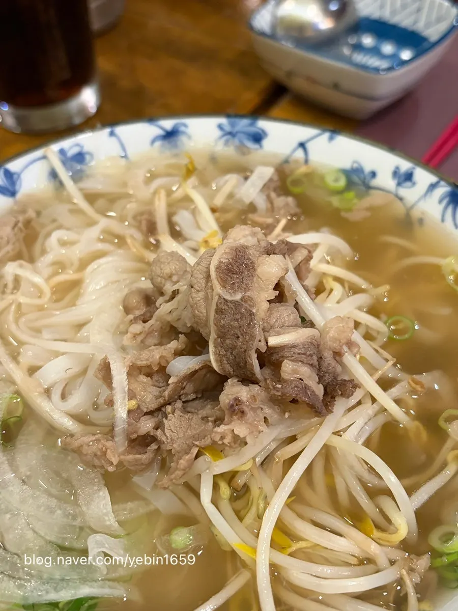A bowl of Vietnamese pho topped with meat