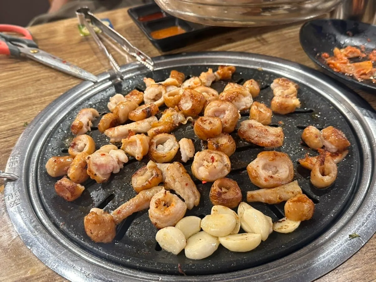 A grilled-meat spread with side dishes and sauces
