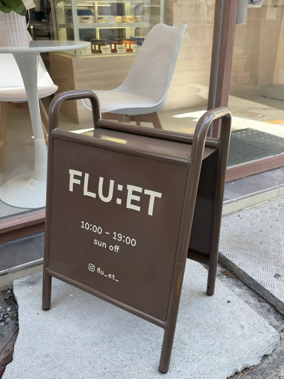 FLU:ET sidewalk sign and glass-front exterior