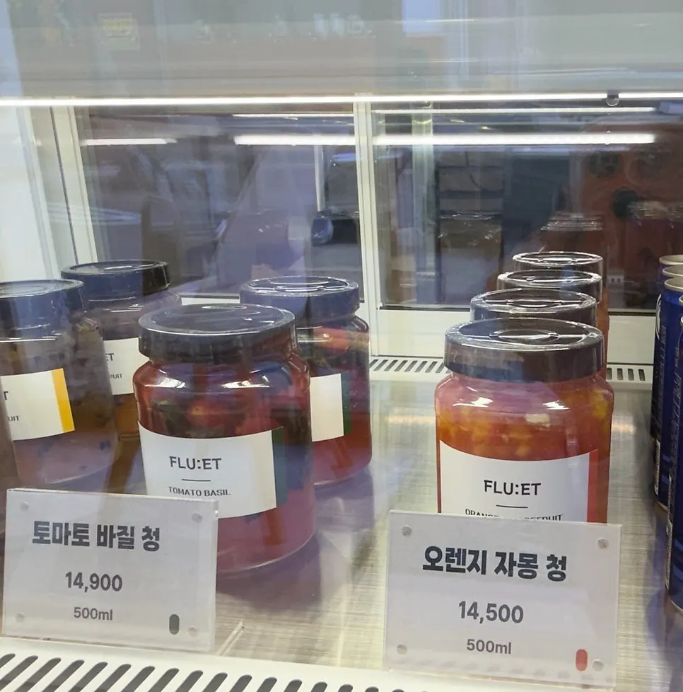 Bottles of various house-made fruit syrups