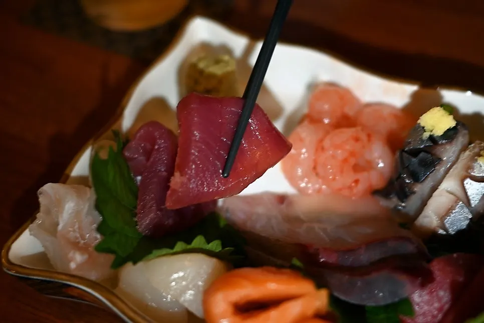 Picking up a thick piece of sashimi