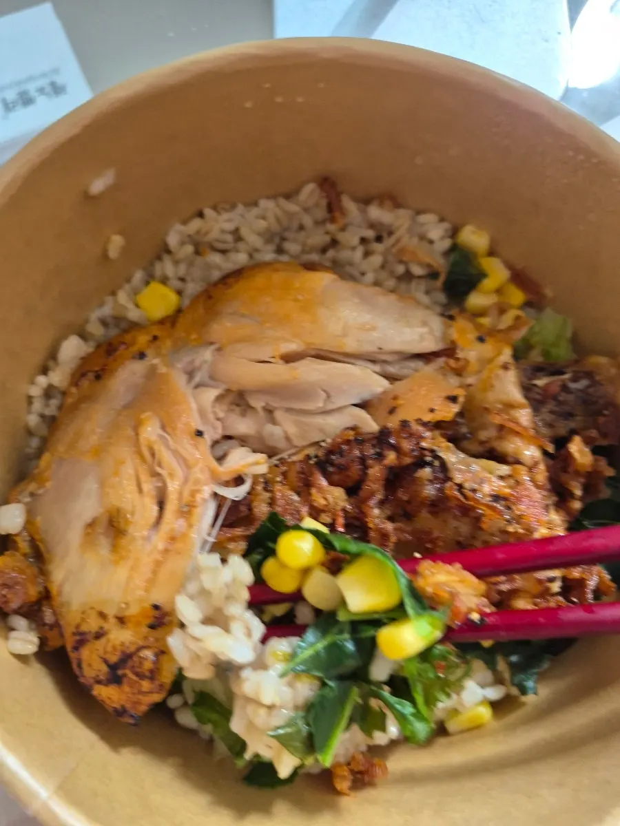 Takeout container of rose onion whole chicken thigh bowl