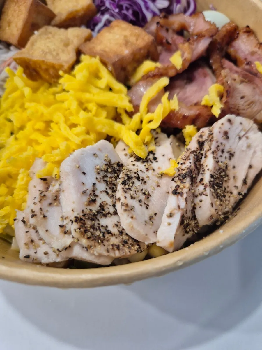 Healthy All-in-One Bibim Poke topped with smoked duck and chicken breast