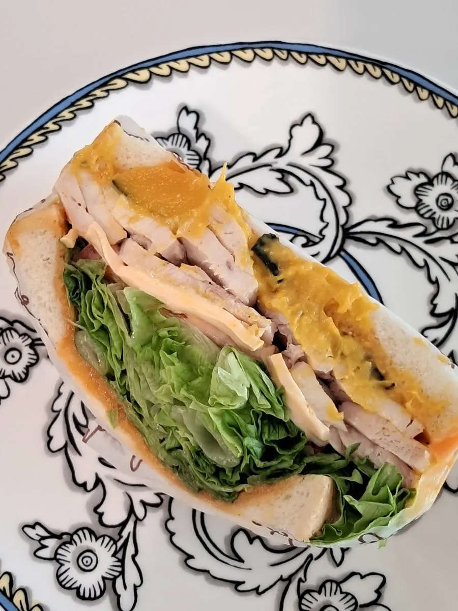 Cross-section of the sandwich packed with sweet pumpkin and lettuce