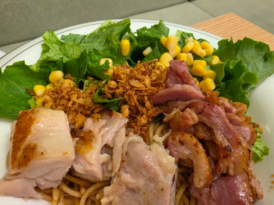 Close-up of all-in-one poke topped with tofu and meat