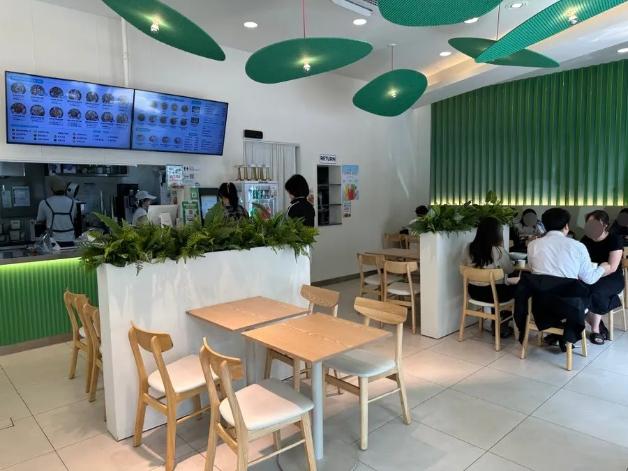 Entrance to Salering Gyodae Direct Store with its green sign