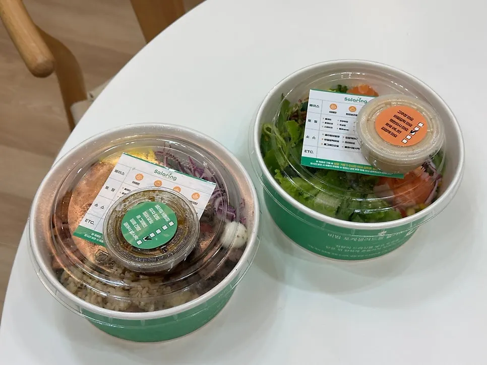 Takeout poke containers with menu stickers from Salering