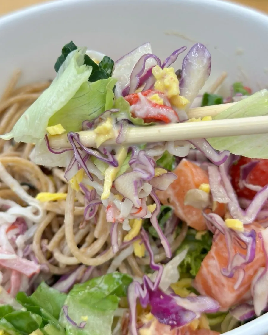 Close-up of poke bowl with raw salmon and vegetables