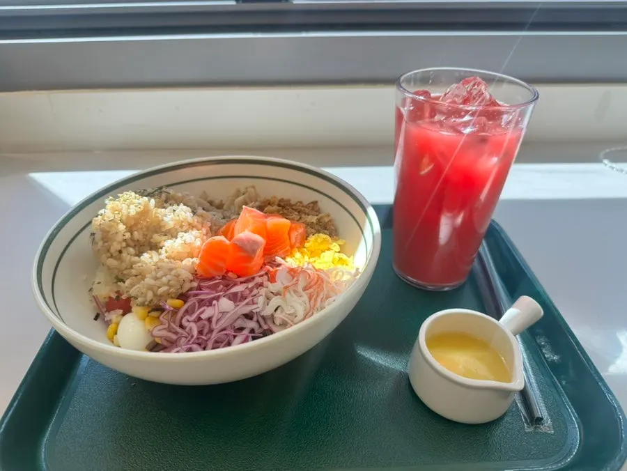 Table setting with raw salmon bibim poke and red cleanse juice