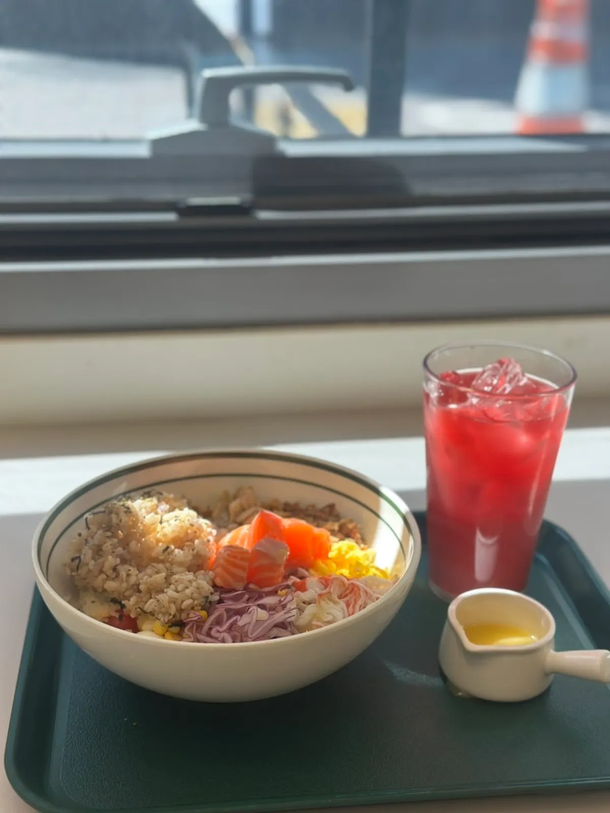 Vertical shot of Salering's raw salmon bibim poke and red cleanse juice