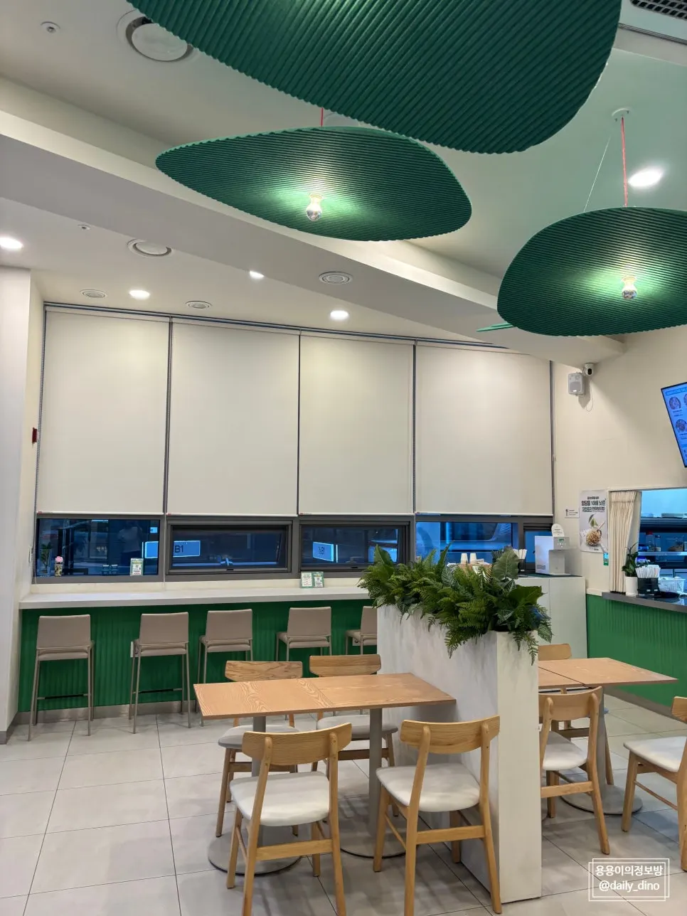 Store seating decorated with wood-tone furniture and plant styling