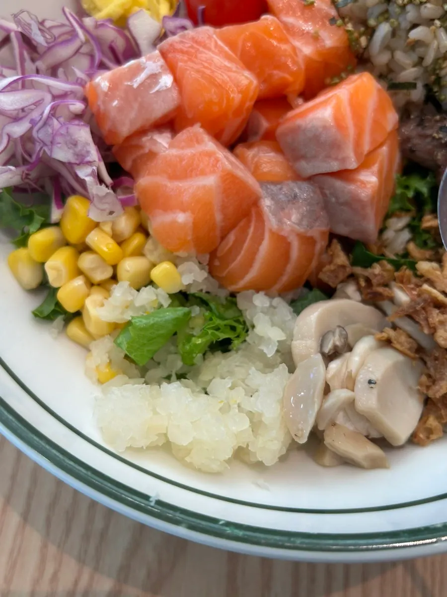 Brown rice poke topped with salmon and grilled steak