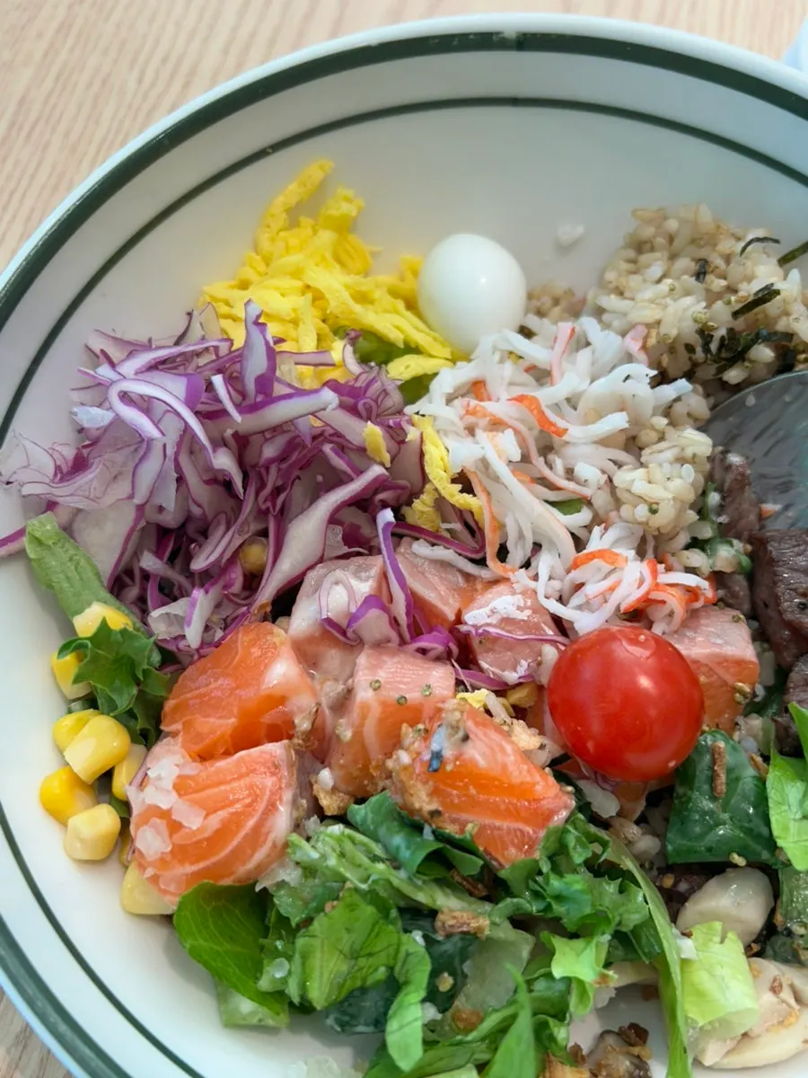 A bite of poke with mixed vegetables and protein