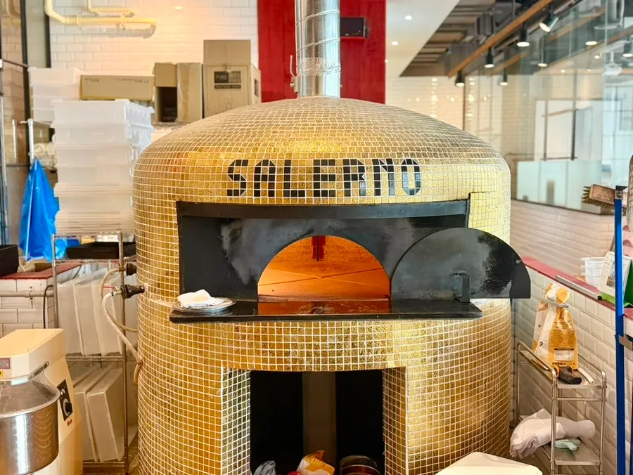 Kitchen area with the wood-fired oven visible