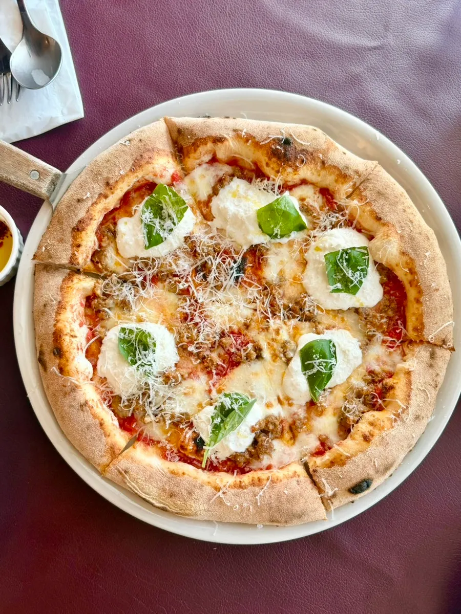 Salsa cha burrata wood-fired pizza topped with burrata cheese