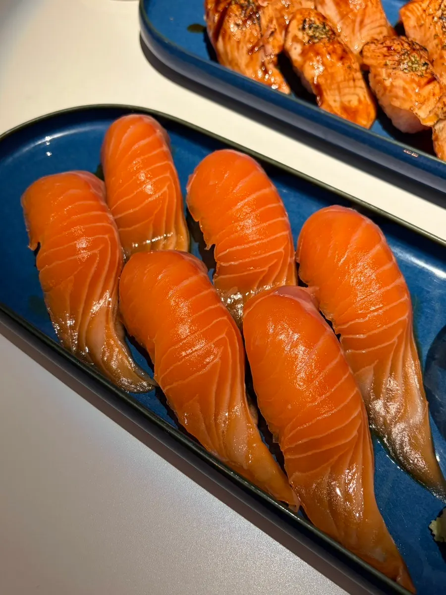 Giant salmon sushi brushed with soy sauce