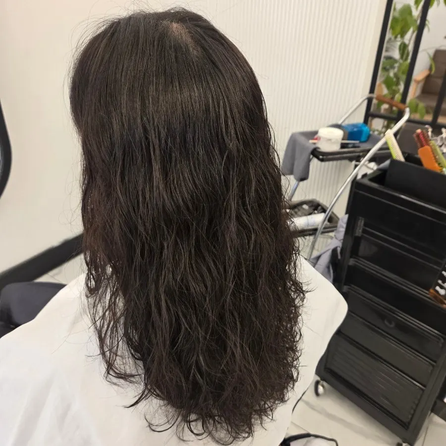 Back view of the curls between a hippie perm and a cloud perm