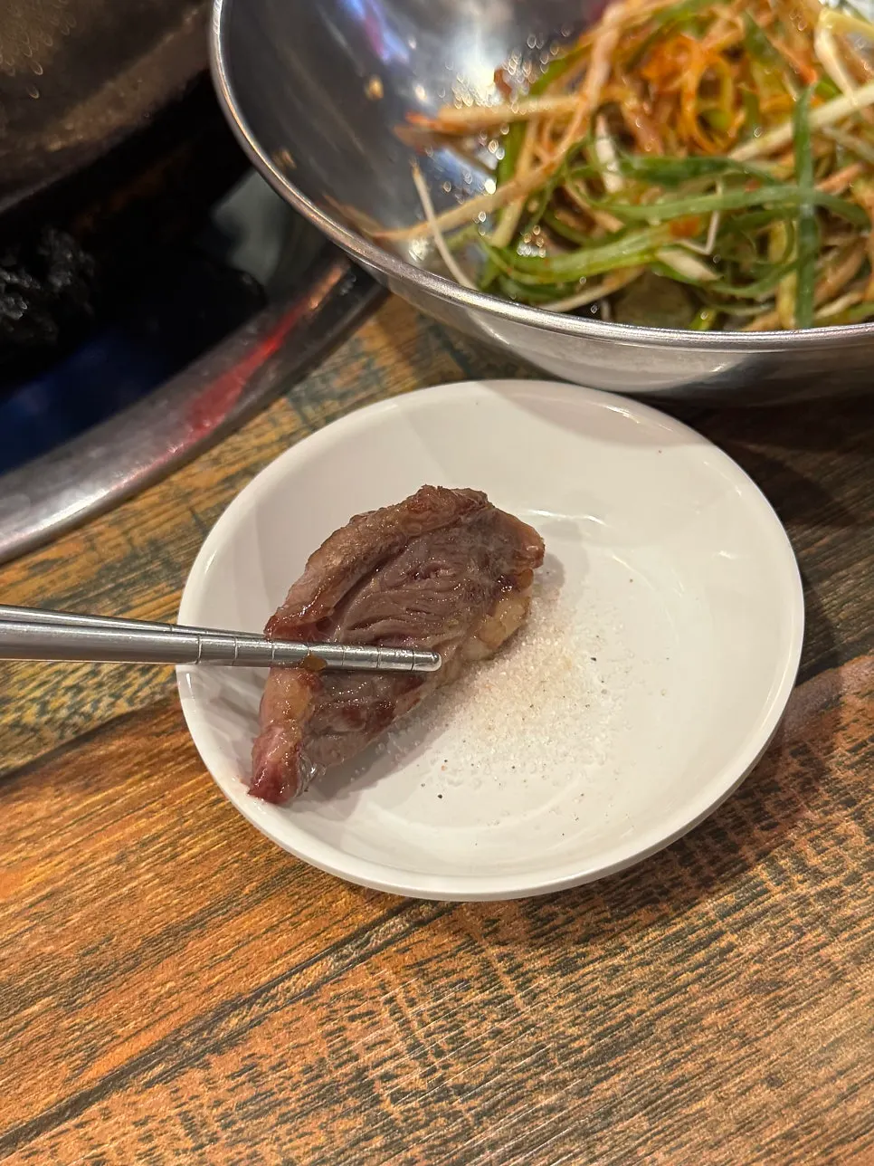 집게로 집어 든 소갈비살 한 점