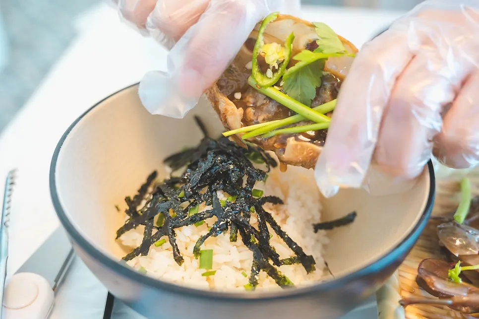 A bowl of rice served alongside the soy sauce crab