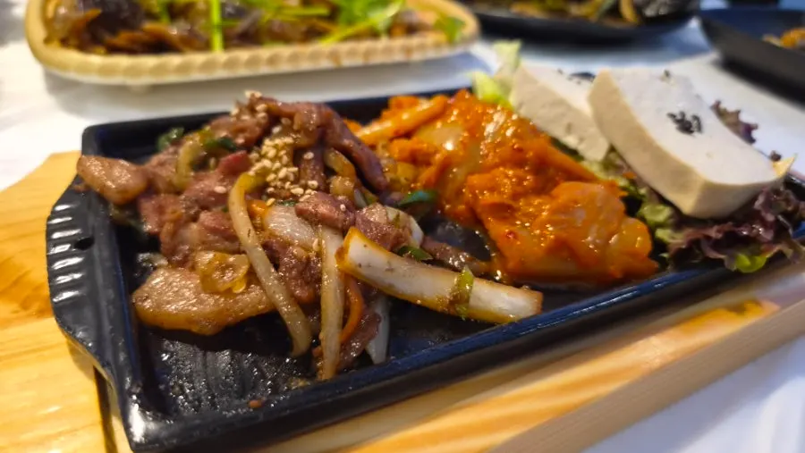 Table with pork belly kimchi tofu and soy crab sauce together