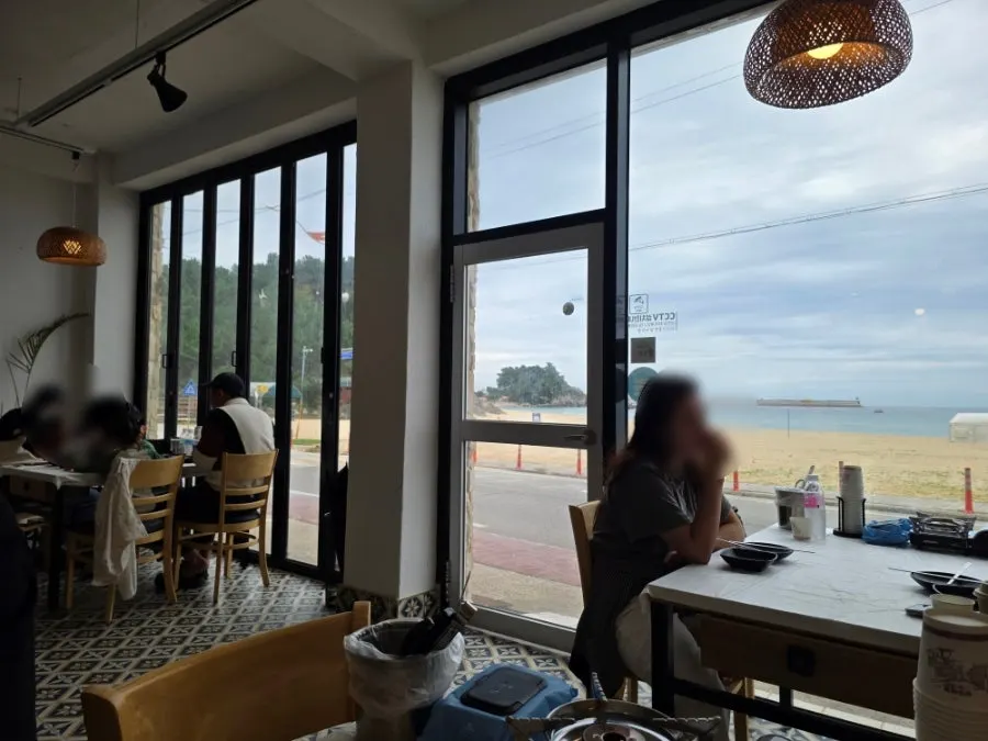 Tables and window seating inside Samcheok Bomulseom