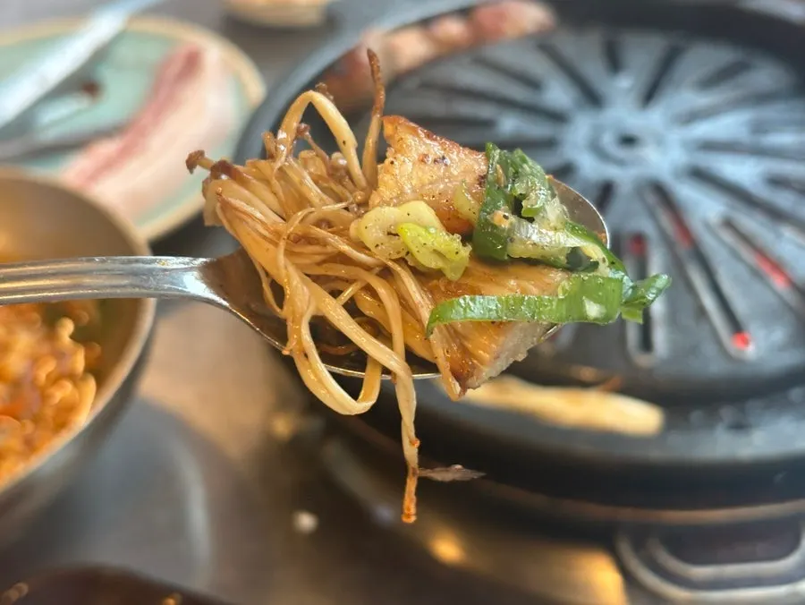 A piece of grilled meat paired with side dishes