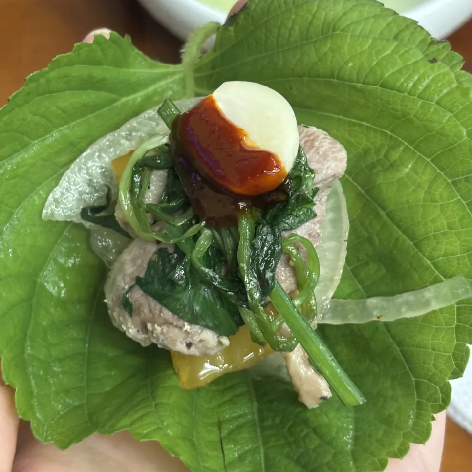 A well-cooked piece of duck loin with grilled garlic