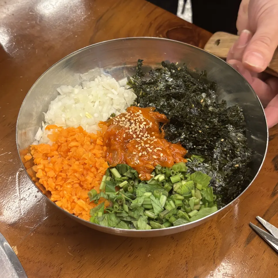 Table setting with naengmyeon served alongside the duck