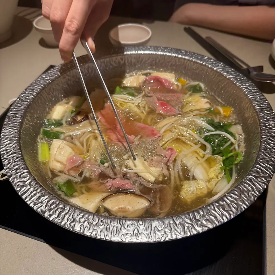 Shabu-shabu vegetables going into the broth