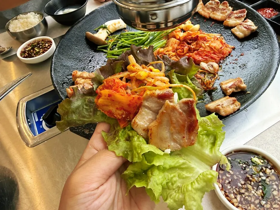 A piece of pork belly dipped in the sauce