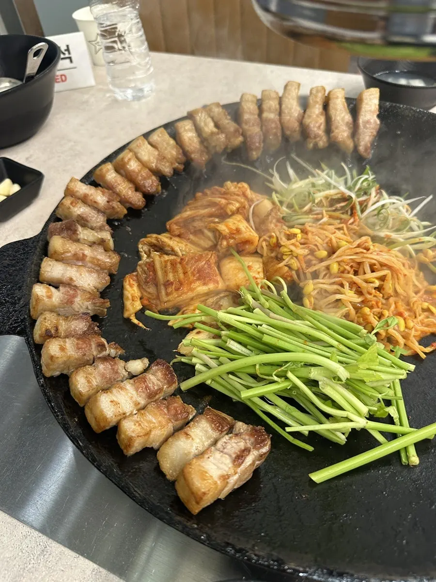 Bean sprouts, scallions and minari added to the pot lid