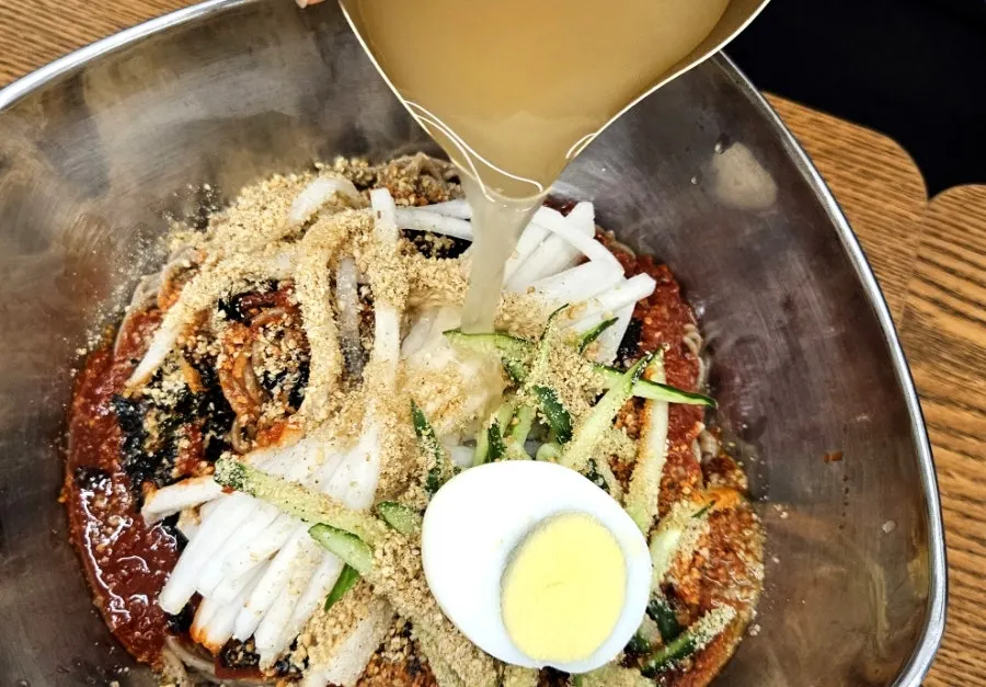 Close-up of bibim makguksu topped with handmade sauce
