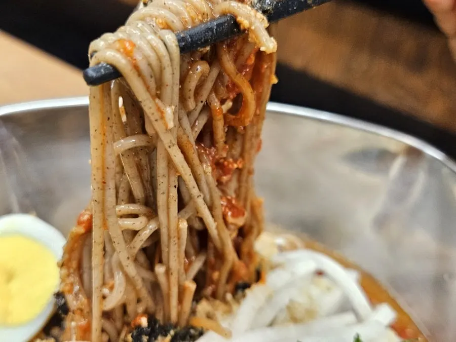 Extra-portion bibim makguksu placed on the table