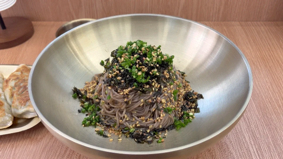 Perilla oil makguksu noodles mixed with chopsticks