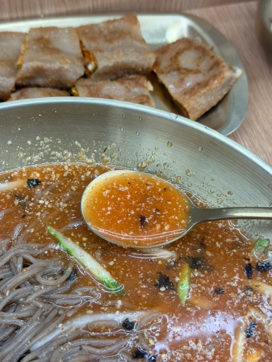 Table spread with makguksu and mandu together
