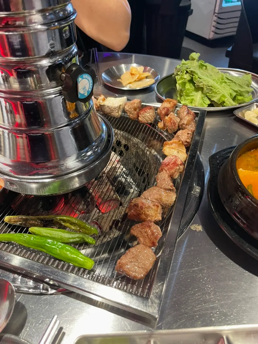 Pork neck wrapped in lettuce with ssamjang and shredded scallion