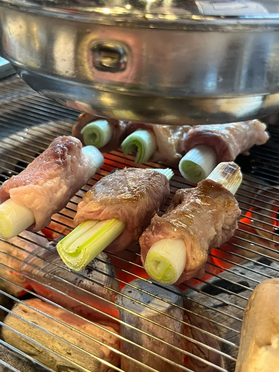Whole scallion galmaegisal cooking on the grill
