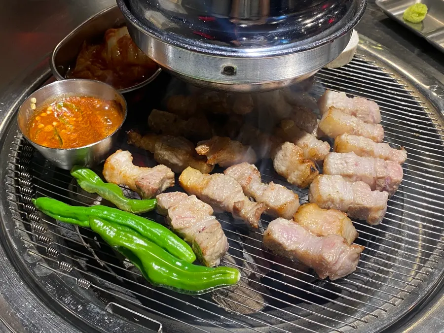 Pork belly grilling on the charcoal grill