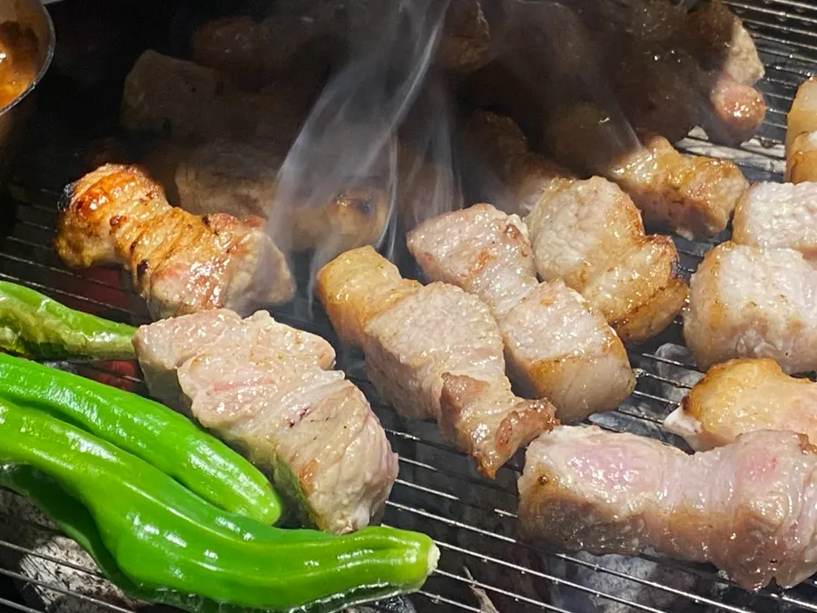 Myeoljeot, kimchi, mushrooms, and cheongyang peppers on the grill