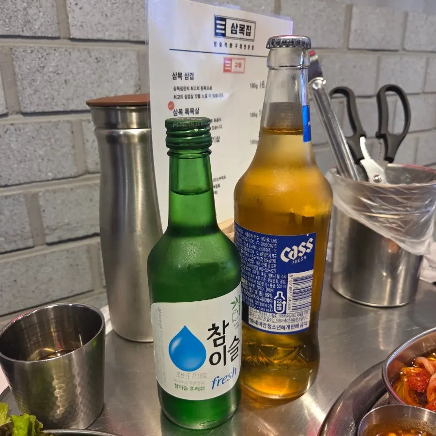 One bottle each of soju and beer on the table