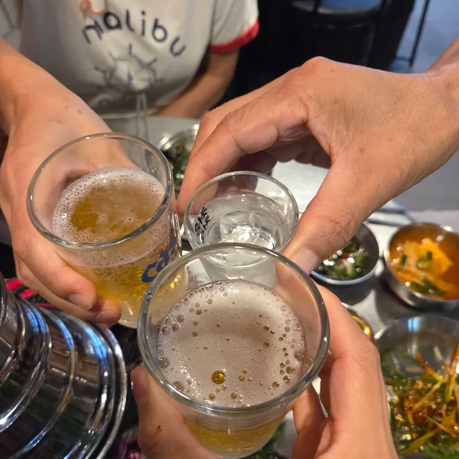 Toasting with soju and beer glasses