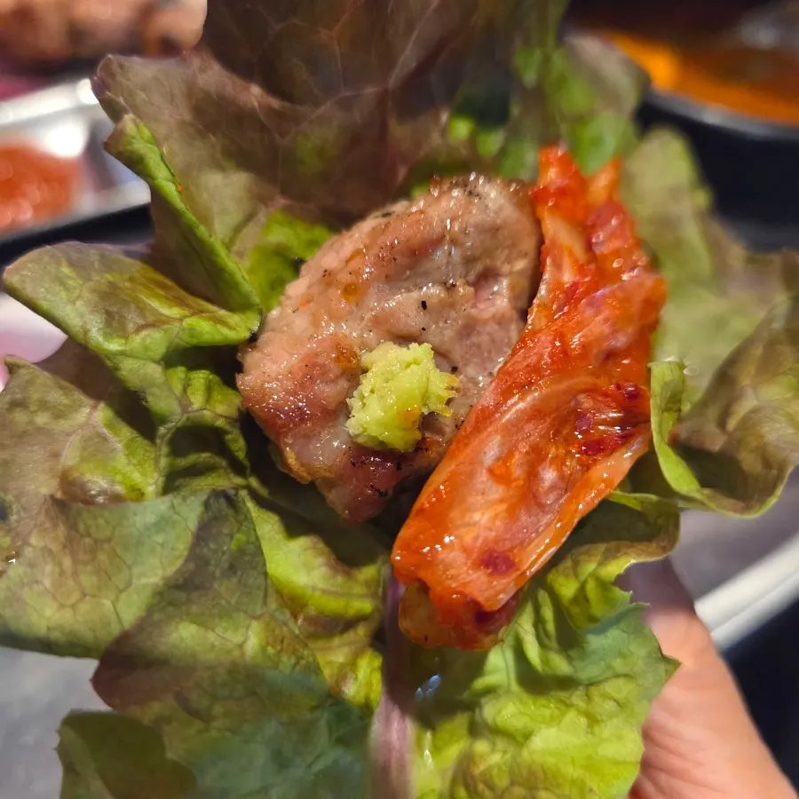 A piece of teukmokssal topped with scallion salad