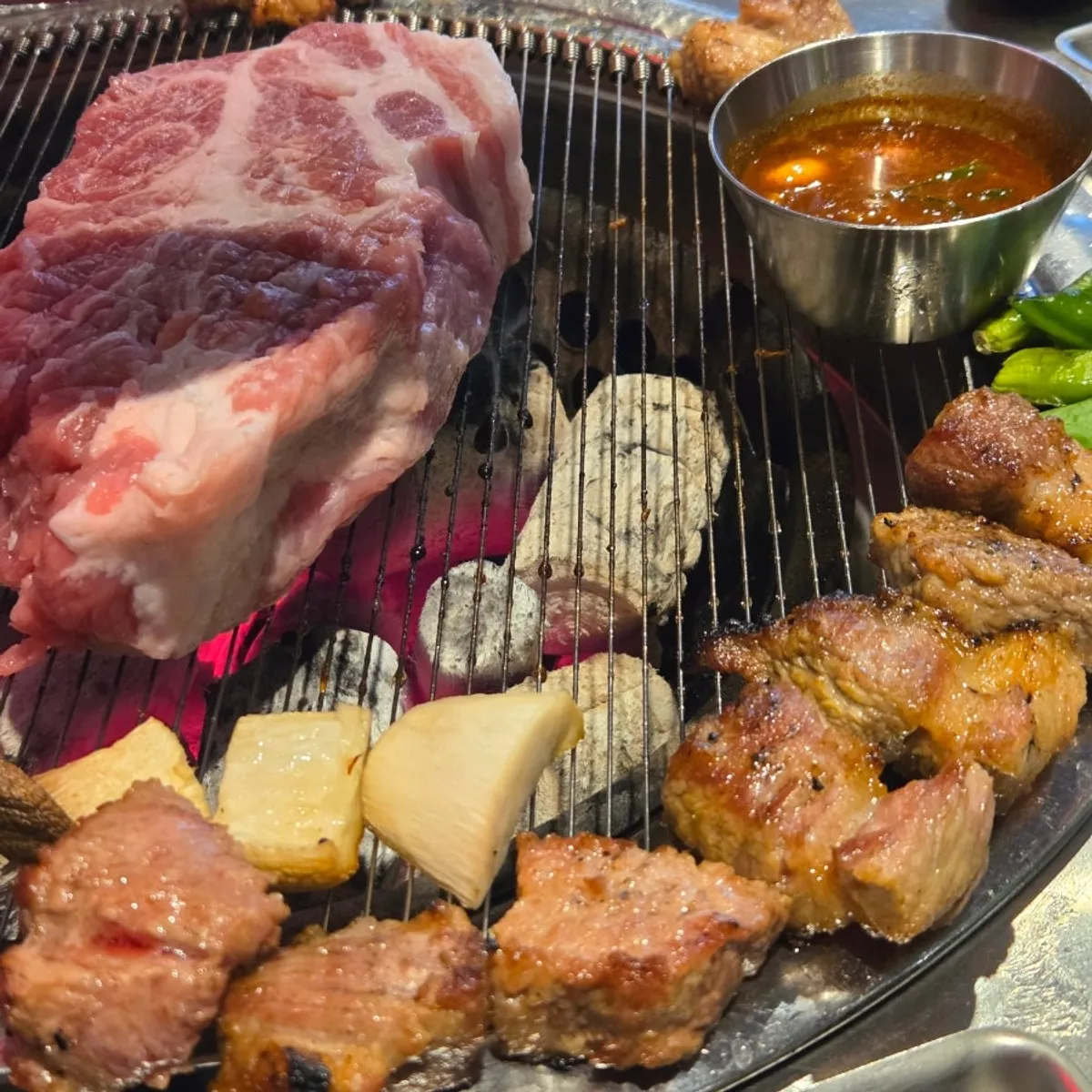Two more servings of teukmokssal added to the grill