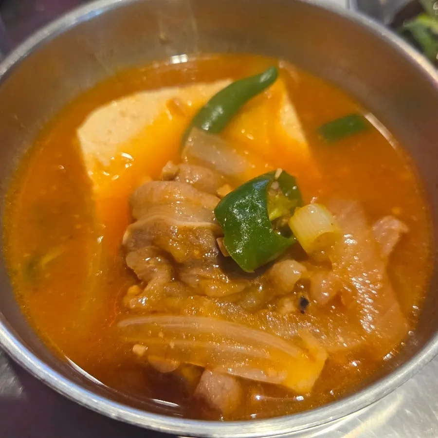 A spoonful of the stew showing the beef brisket